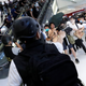 Plainclothes police officers use pepper spray to disperse protesters inside a mall in Hong Kong, July 14, 2019.